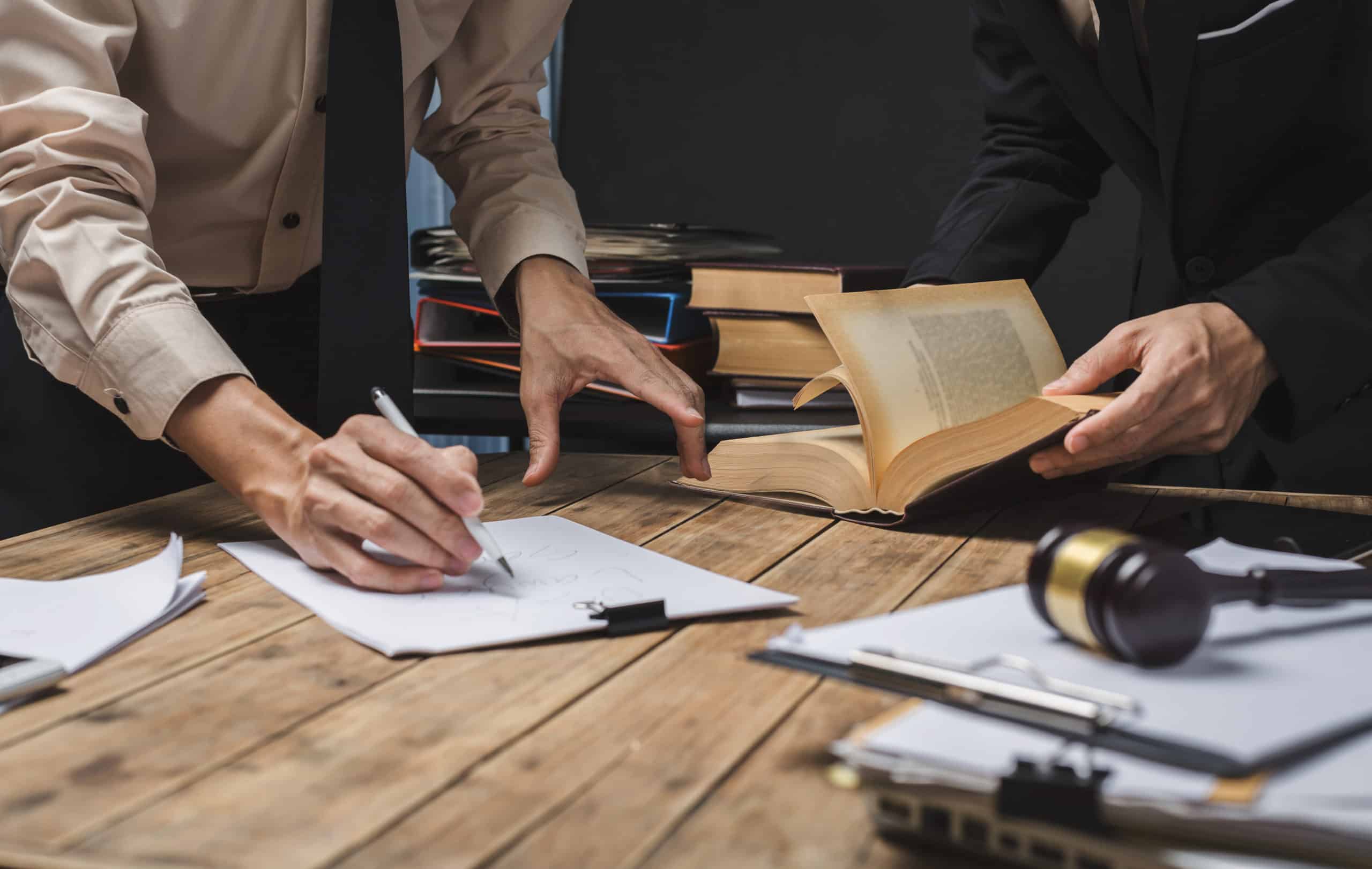 Teamwork of business lawyer meeting working hard about legal regislation in courtroom to help their customer.