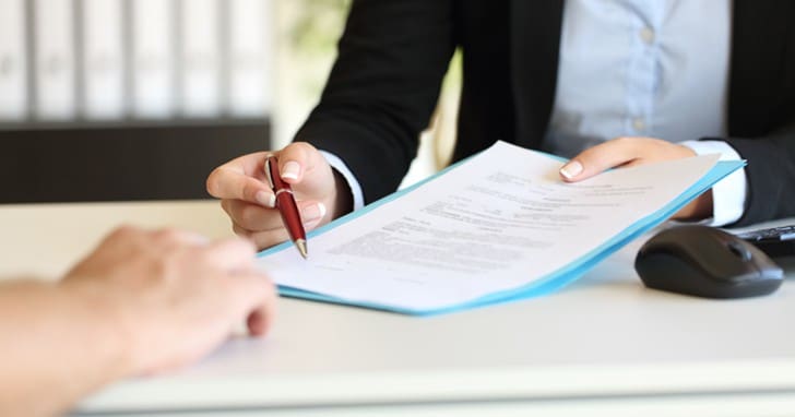 Executive hands indicating where to sign contract